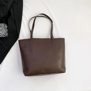 Close-up of large capacity dark brown tote bag with premium crocodile skin texture