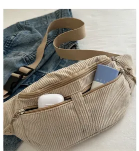 Detail view of large capacity corduroy chest bag showing inner storage with accessories
