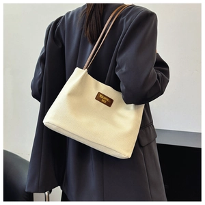 Close-up of cream corduroy tote bag with vertical texture and brown leather straps
