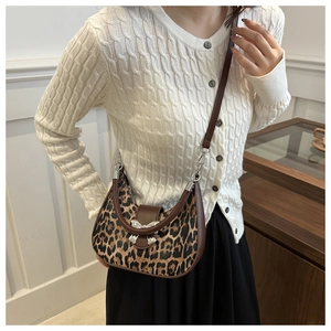 Détail du sac croissant à imprimé léopard avec boucle nœud argenté sur modèle