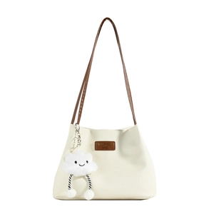 Chic beige lattice pattern tote bag with brown straps and cute plush cloud charm
