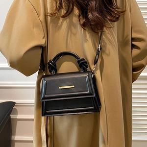 Minimalist black PU leather crossbody bag with knot handle and gold hardware detail