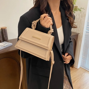 Minimalist beige crossbody square handbag with unique knot handle and gold metal trim