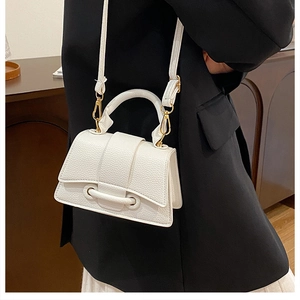 Detail of white lychee texture leather mini crossbody bag with gold-tone hardware