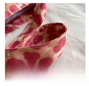 Detail of pink leopard print wide canvas shoulder strap with high-density stitching