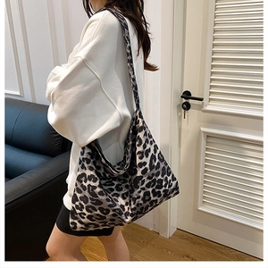 Lifestyle shot of large leopard print tote bag worn on shoulder for daily use