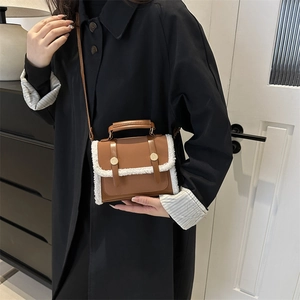 Vintage brown crossbody flap bag with white faux fur trim and gold buckle details