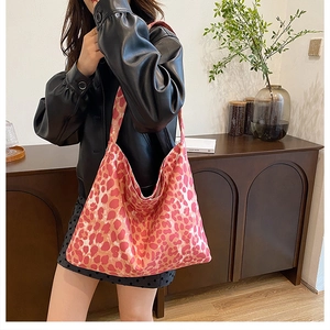 Detail view of pink and red leopard print tote bag in durable canvas fabric