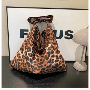 Detailed view of large leopard print canvas tote bag with integrated shoulder strap