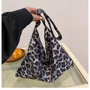 Detail of grey leopard print fabric tote bag with triangular design and wide handle