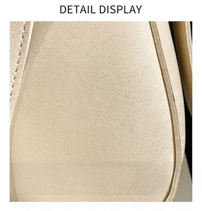 Close-up of beige faux leather with pebble grain texture and precise stitching detail