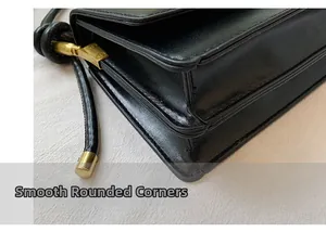 Detailed view of the rounded corners and smooth black glossy leather on the shoulder bag