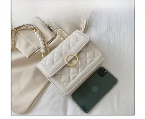 Detailed size comparison of beige quilted pearl flap bag with a smartphone reference