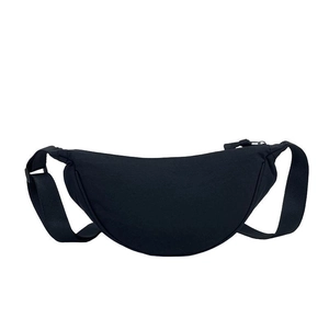 Minimalist black nylon crescent crossbody bag with adjustable strap on white background