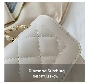 Detailed close-up of quilted stitching and gold chain strap on cream shoulder bag