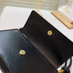 Classic black leather baguette shoulder bag featuring a secure golden magnetic closure