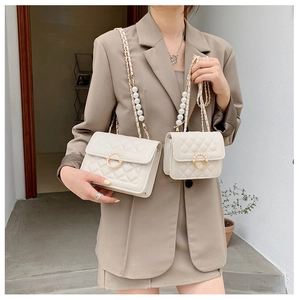 Detailed comparison of large and small white quilted bags with pearl chain straps