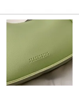 Close-up of avocado green lychee pattern leather with JIASHIQING brand embossed detail