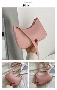 Detailed view of pink crescent dumpling bag with golden hardware and slender strap