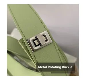 Close-up of the silver hardware twist lock and stitching on this light green handbag