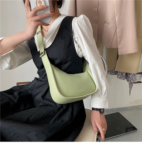 Detail of avocado green half-moon crossbody bag with adjustable wide strap and silver buckle