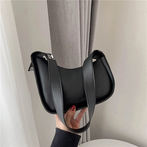 Minimalist black crescent moon underarm bag in matte finish leather with wide strap