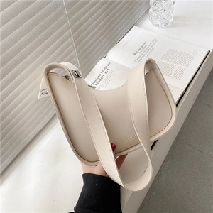 Minimalist creamy white hobo shoulder bag with irregular shape and smooth leather texture