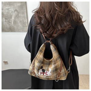 Detail of plaid tote bag featuring a cute puppy illustration and leather shoulder straps