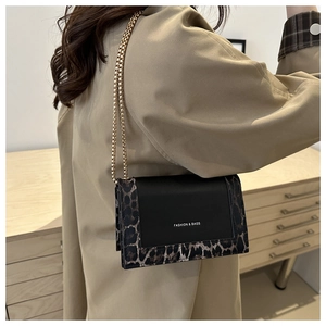 Chic leopard print and black square bag worn with a beige trench coat and gold chain
