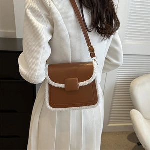 Brown faux leather crossbody bag with white fleece trim and square buckle detail