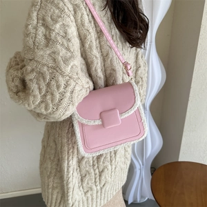 Pink faux leather square crossbody bag with white faux shearling trim and adjustable strap