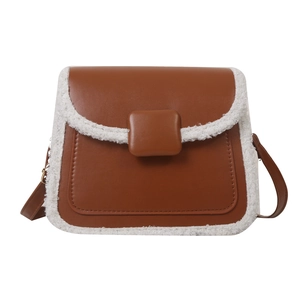 Vintage brown crossbody bag with white faux shearling trim and matte leather finish