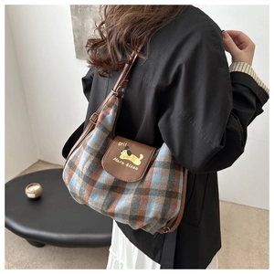 Detail of checkered crossbody bag with leather flap and cute cartoon dog pattern