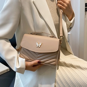 Chic beige quilted crossbody bag with enamel butterfly clasp and slim shoulder strap