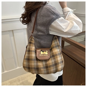 Detail of retro tote bag with brown plaid fabric and a cute cartoon dog print