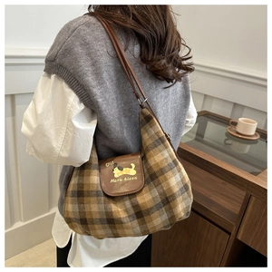 Detail of vintage brown plaid tote bag featuring a cute cartoon dachshund leather flap