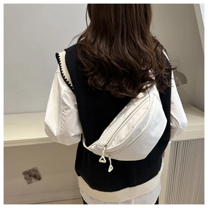 Rear view of model wearing a white nylon crossbody chest bag with checkered texture