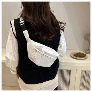 Detailed view of a white checkered nylon crossbody bag with adjustable strap and buckle