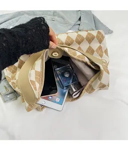 Spacious interior of argyle canvas tote bag showing tablet, perfume and umbrella