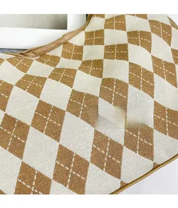 Close-up of brown and white knitted diamond pattern fabric on a stylish tote bag