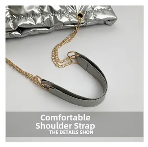 Detail of comfortable silver leather strap and golden chain on quilted tote bag