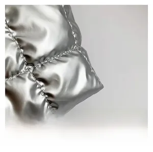 Close-up of metallic silver quilted tote bag fabric with premium diamond stitching texture