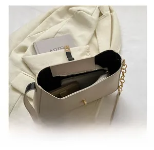 Detailed interior of a beige half-moon saddle bag showing large capacity and zipper pocket