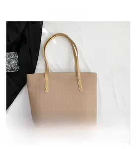 Detail view of beige quilted tote bag with large capacity and double shoulder straps