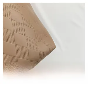 Close-up of light brown leather tote bag with quilted pattern and breathable texture