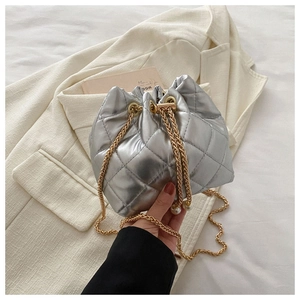 Detail of silver quilted bucket bag with gold chain straps and pearl charms