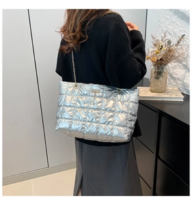 Detail of silver quilted space cotton tote bag with metal chain strap and metallic finish