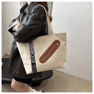 Grand sac cabas en toile beige avec poche en cuir marron et détail de sangle
