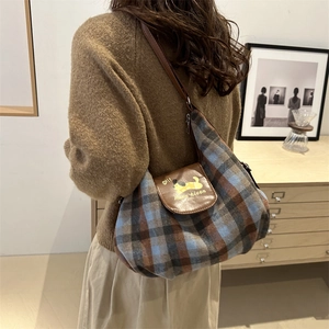 Plaid canvas tote bag with brown leather flap featuring a cartoon dachshund print