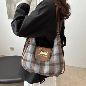 Retro plaid tote bag with brown leather flap and dog embroidery on adjustable shoulder strap